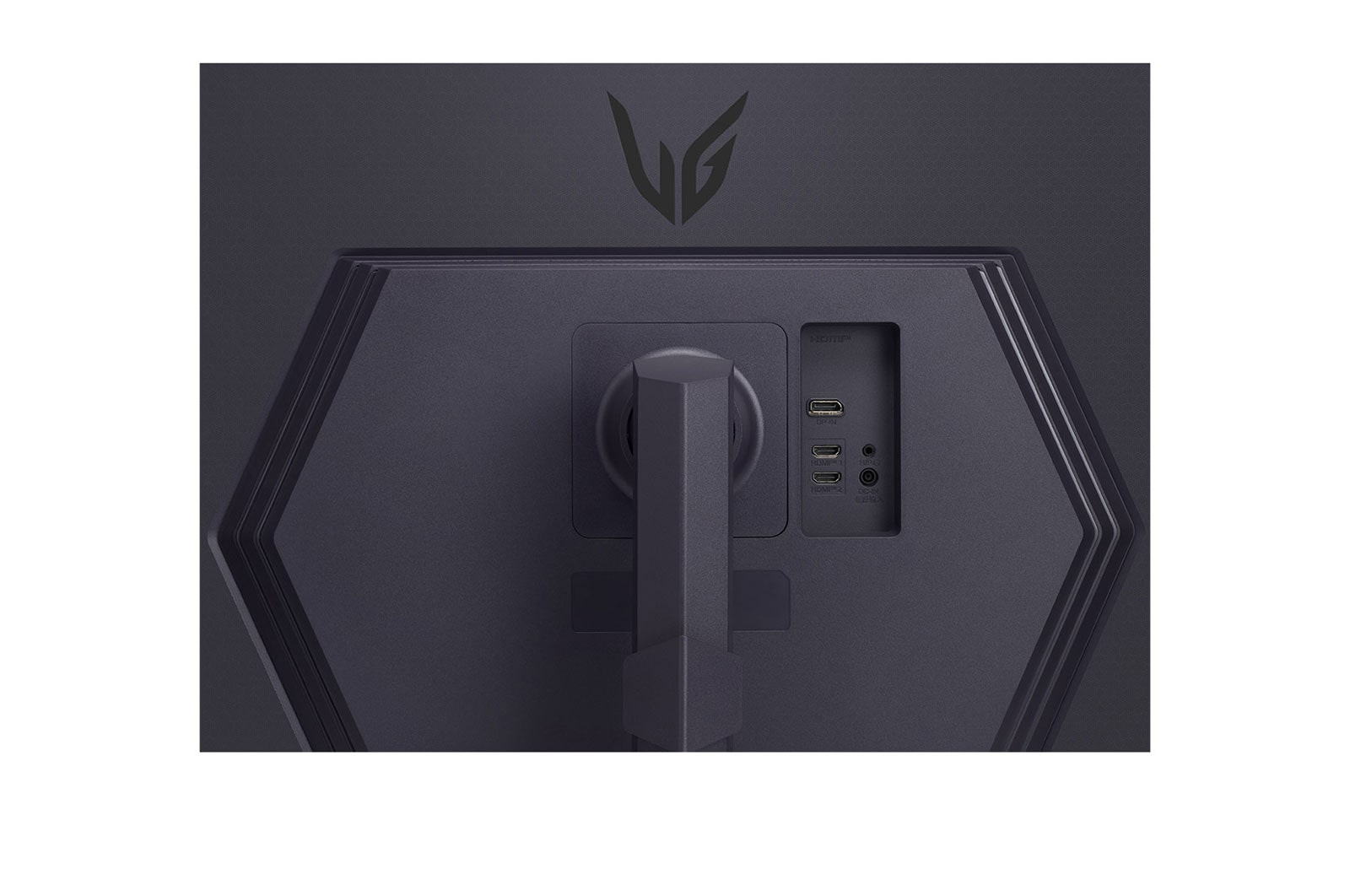 Tył ciemnego monitora z portami, logo LG i podstawką. Porty obejmują HDMI, USB i zasilanie. Monitor ma sześciokątny kształt.