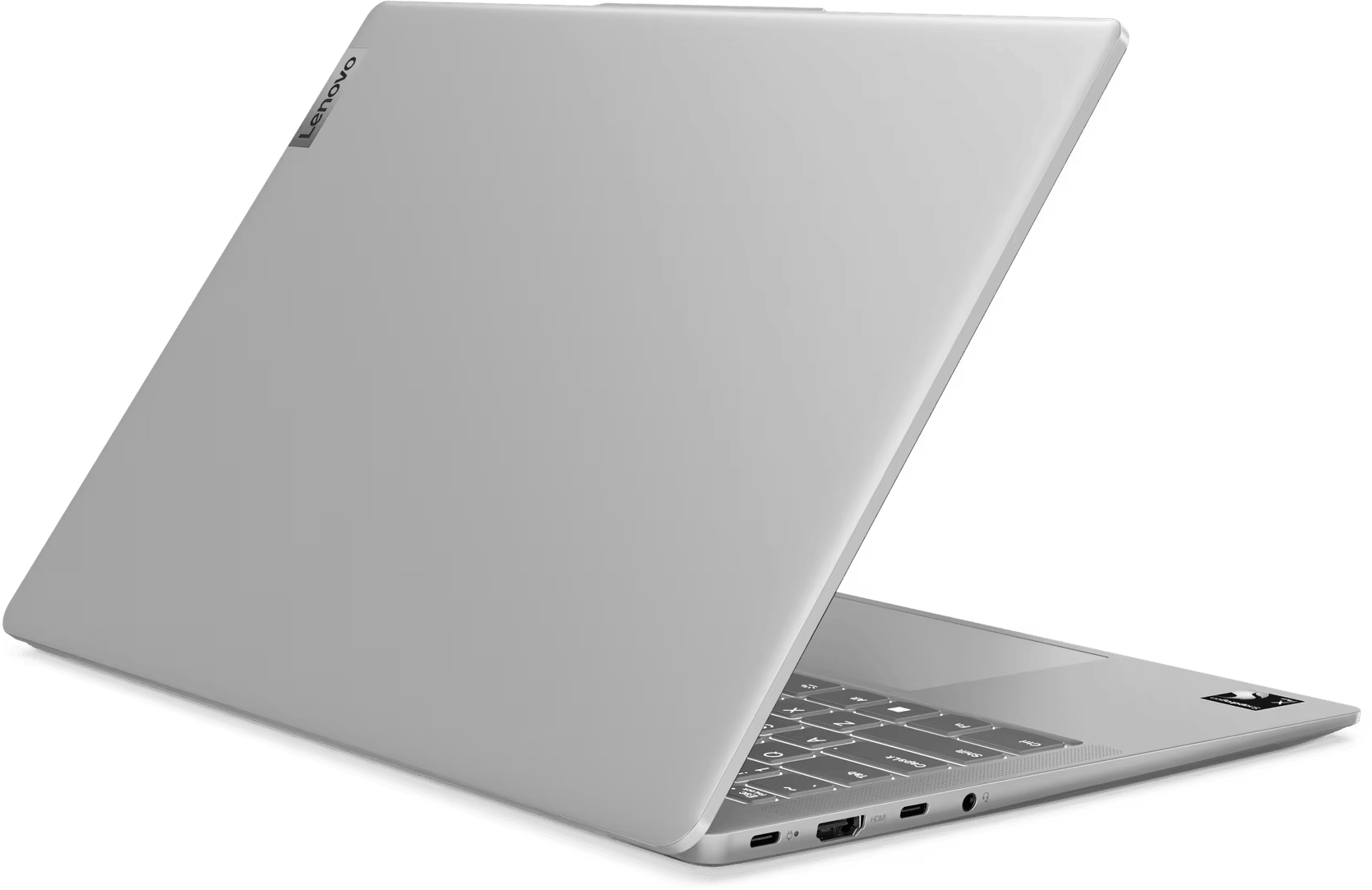Egy ezüst Lenovo laptop kissé nyitva van. A billentyűzet látható. A háttér egyszínű sötétzöld.