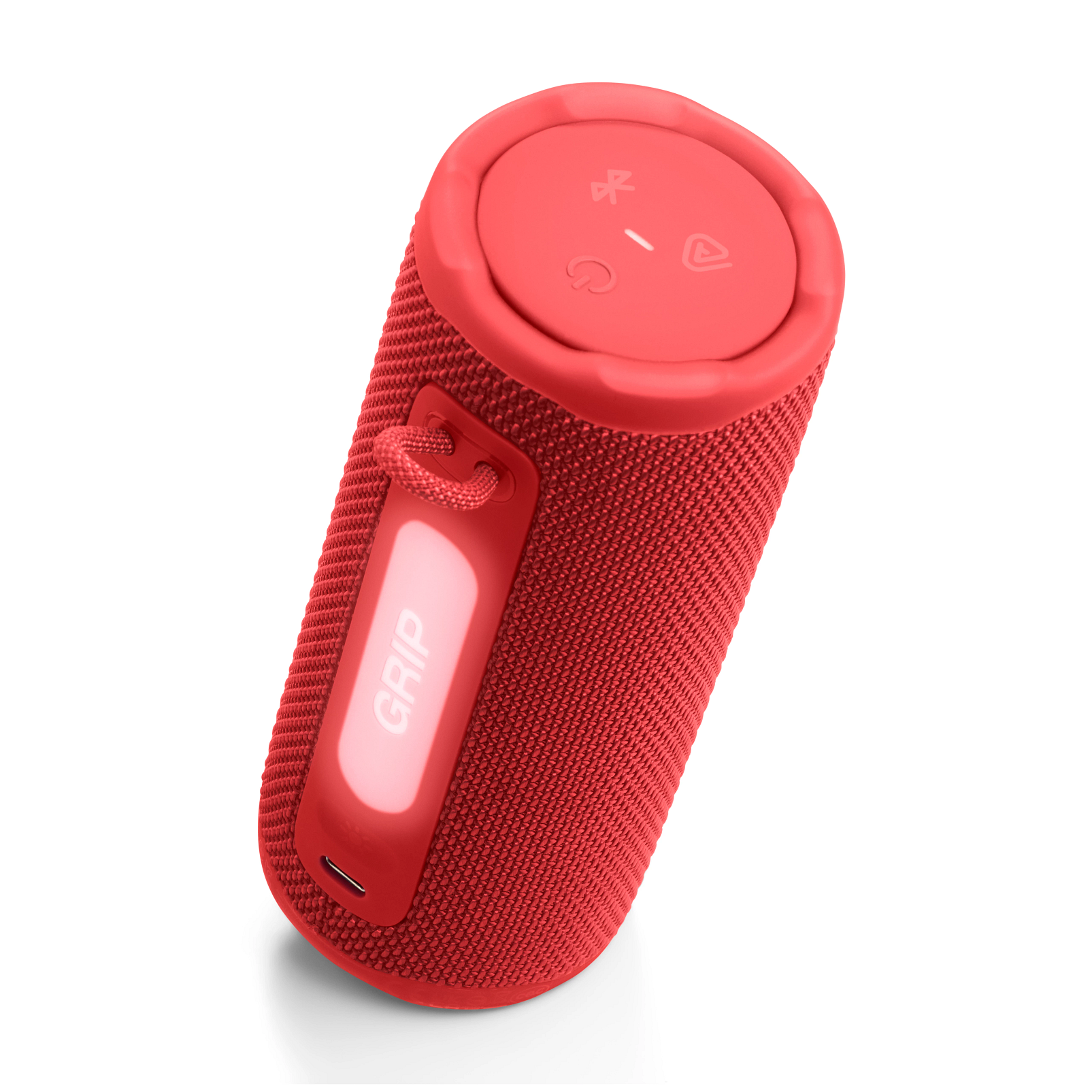 Piros hengeres hangszóró a 'GRIP' szóval, gombokkal és Bluetooth szimbólummal a tetején, fehér háttér előtt.