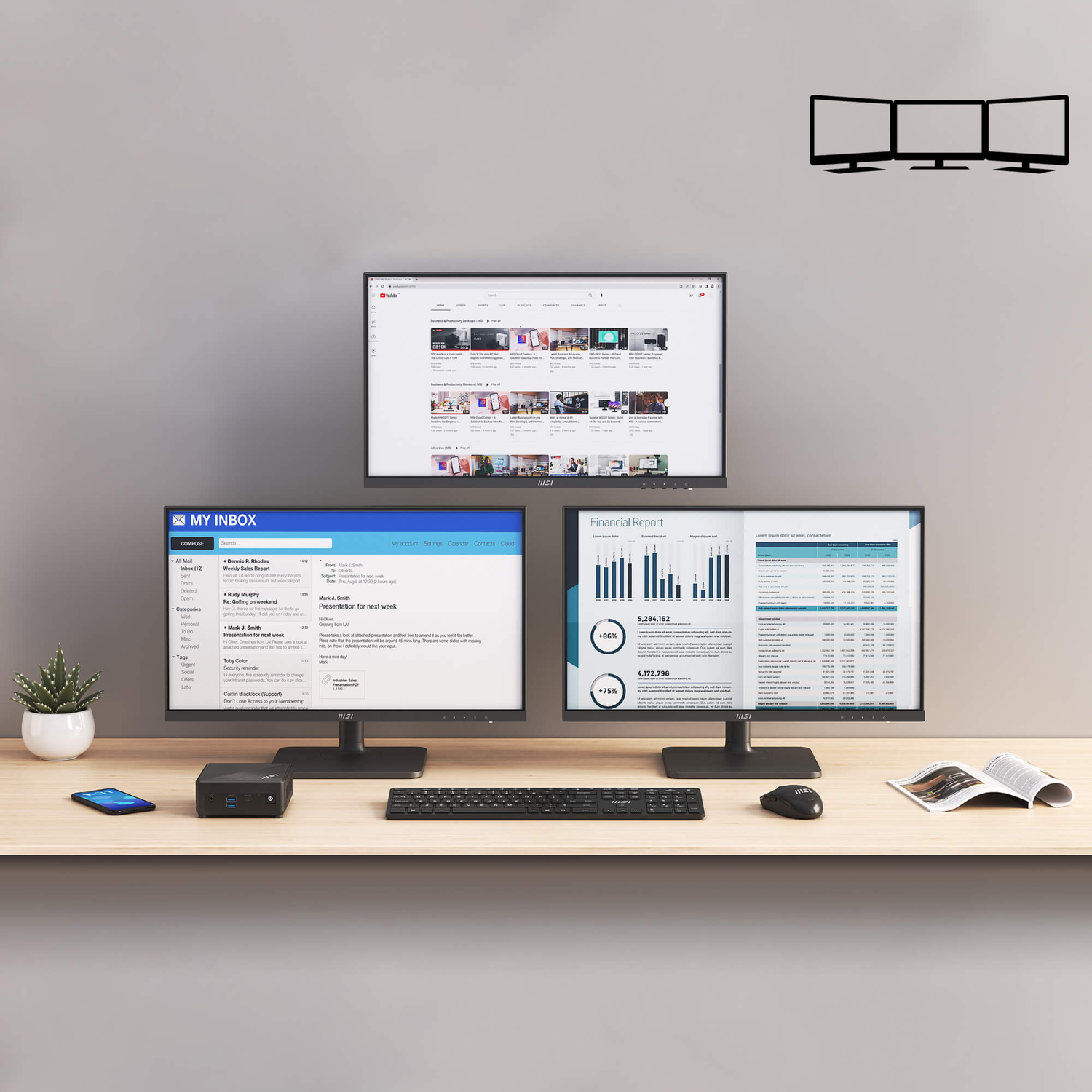 A desk with three monitors displays financial reports, emails, and YouTube. There is a keyboard, mouse, phone, and a small plant.