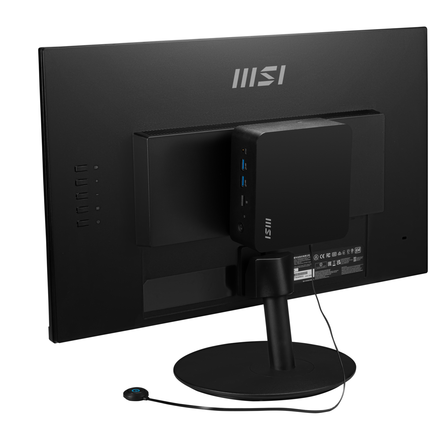 A black monitor with a black mini PC attached to its back. A round button is connected. The MSI logo is visible.
