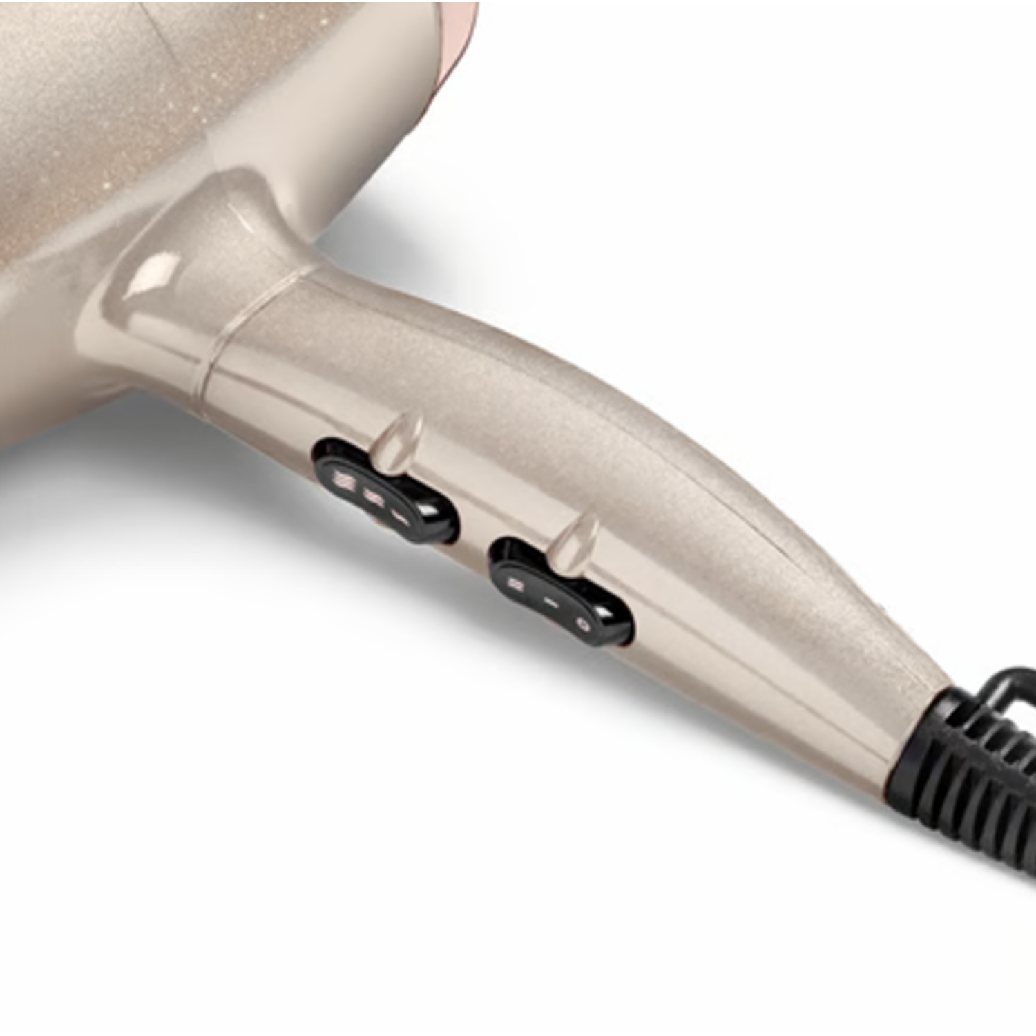 A beige hairdryer with black switches and a black cord lies on a white surface. The hairdryer is angled, showing its handle and head.