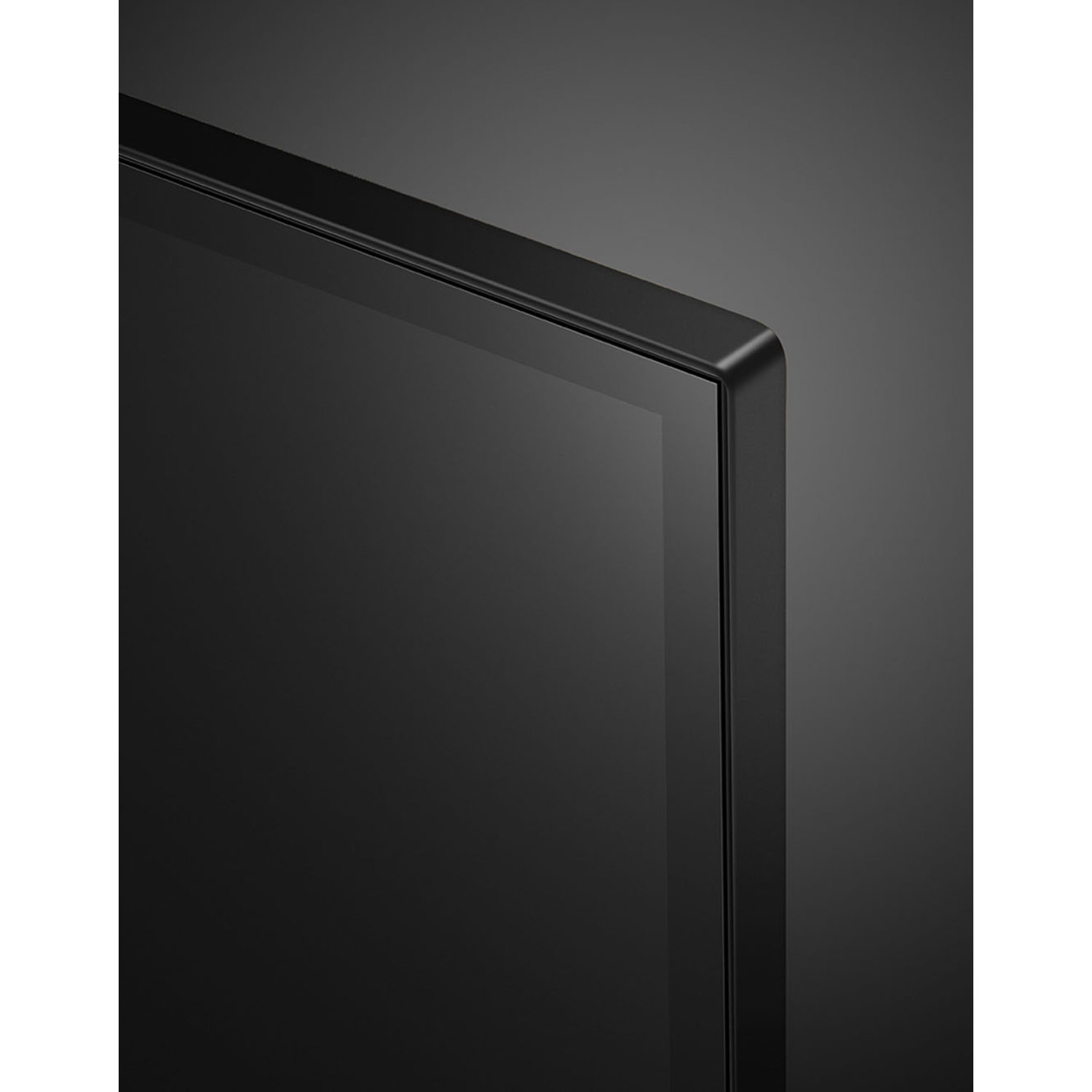 Close-up of a black flat-screen TV. The corner is visible, with a black frame and a dark screen against a gray background.
