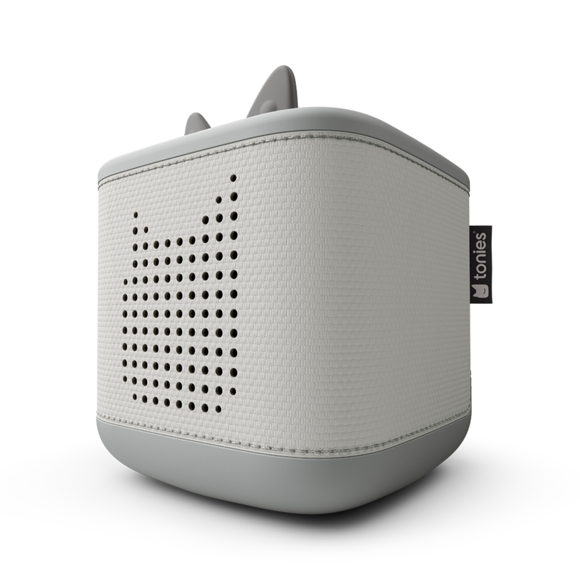 Eine grau-weiße Toniebox, ein würfelförmiger Lautsprecher mit perforierter Vorderseite, die eine Katzensilhouette bildet. Oben befinden sich zwei Ohren.