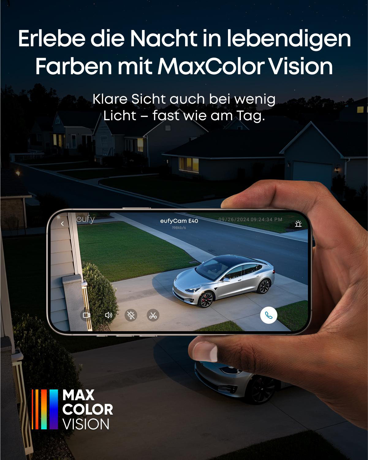 Eine Hand hält ein Telefon, das ein Auto in einer Einfahrt zeigt. Text sagt 'Max Color Vision'. Häuser sind im Hintergrund.