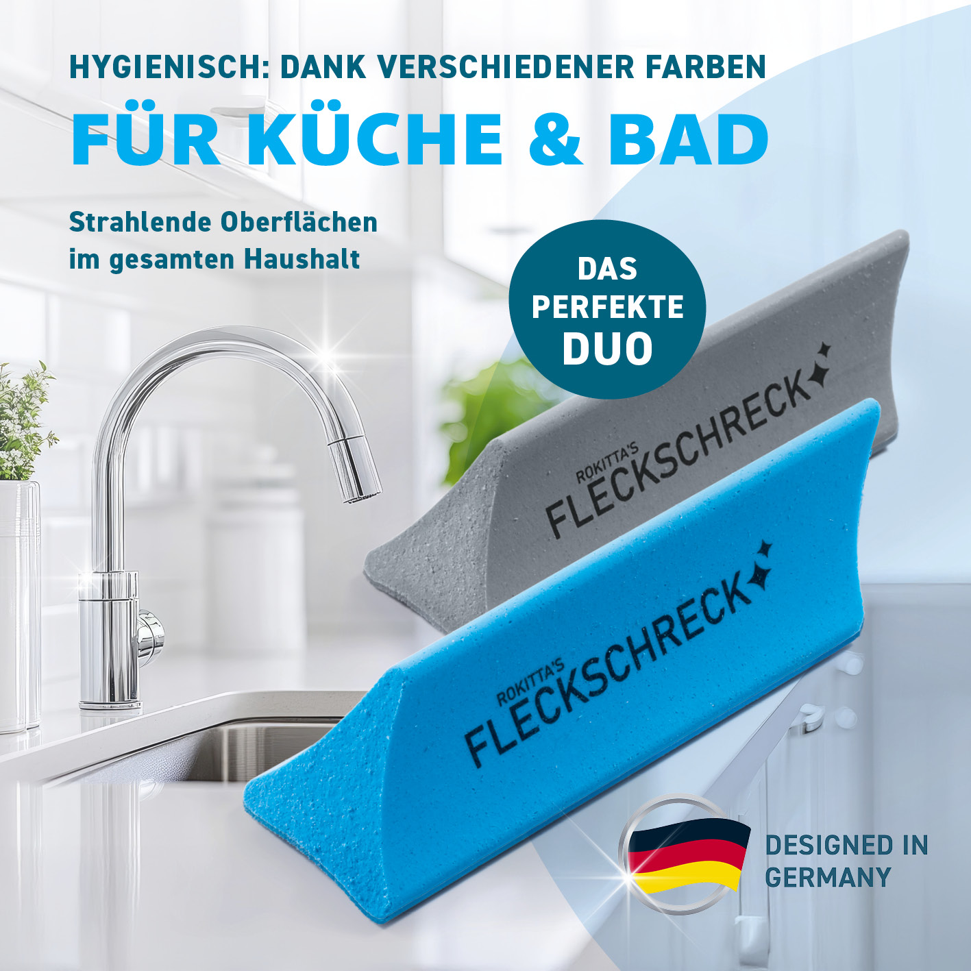 Das Bild zeigt zwei Reinigungswerkzeuge. Eines ist blau, das andere grau. Der Text darauf lautet 'Fleckschreck'. Der Hintergrund zeigt ein Küchenbecken.