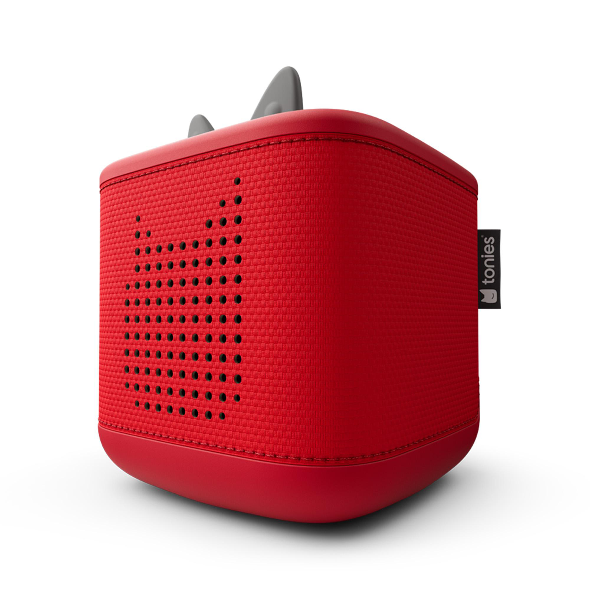 Rote, würfelförmige Toniebox. Sie hat ein Lautsprechergitter mit Löchern, zwei graue Ohren oben und ein 'tonies'-Etikett.