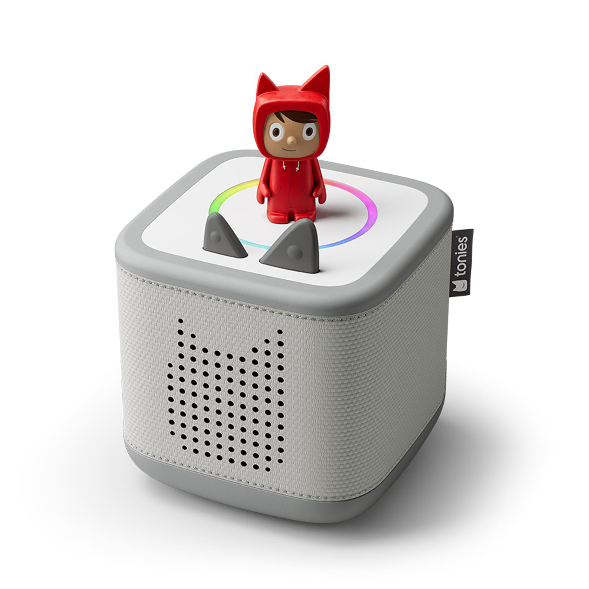 Ein weiß-grauer Lautsprecher mit einer roten Figur oben. Der Lautsprecher hat graue Ohren und ein Regenbogenlicht.