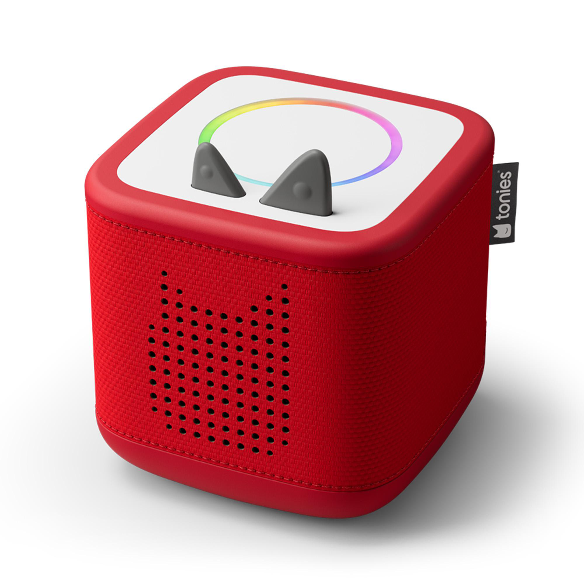 Rote Toniebox mit grauen Ohren, einem weißen Oberteil mit Regenbogenring und einem 'tonies'-Etikett. Sie steht auf weißem Hintergrund.
