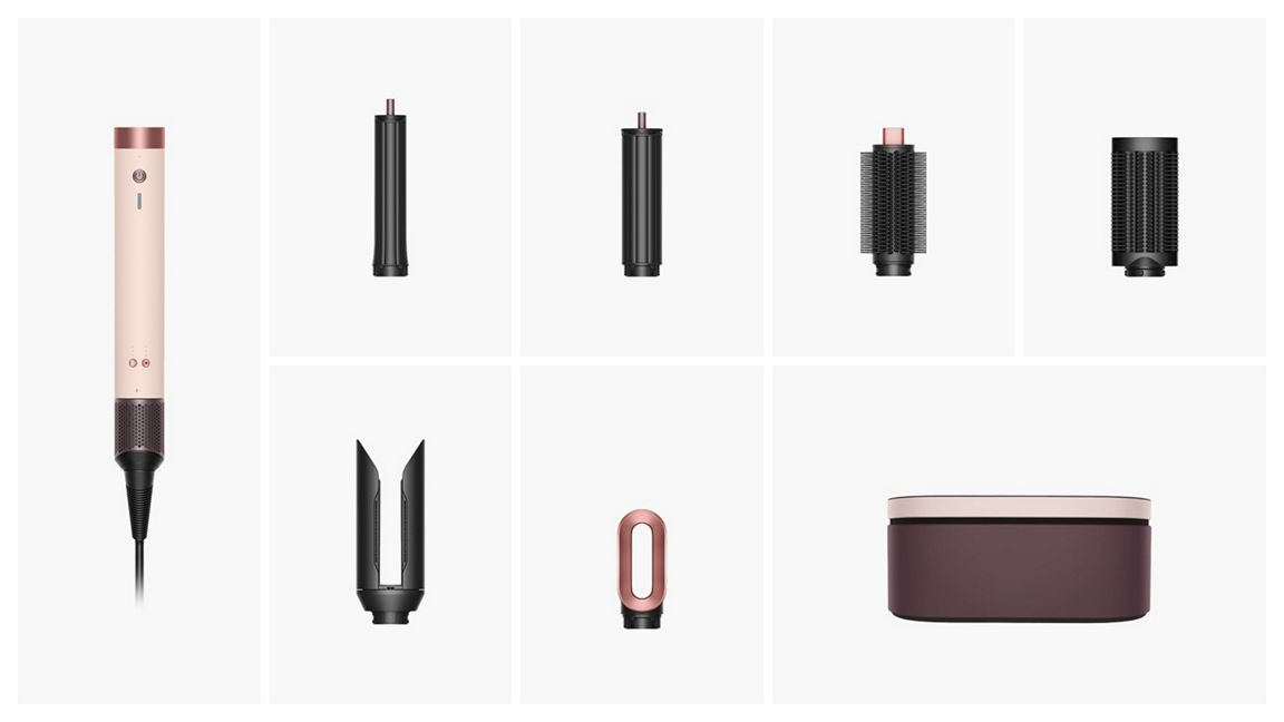Ein Haarstyling-Set mit einem rosa-kupferfarbenen Haartrockner, verschiedenen schwarzen Aufsätzen und einer Aufbewahrungsbox.