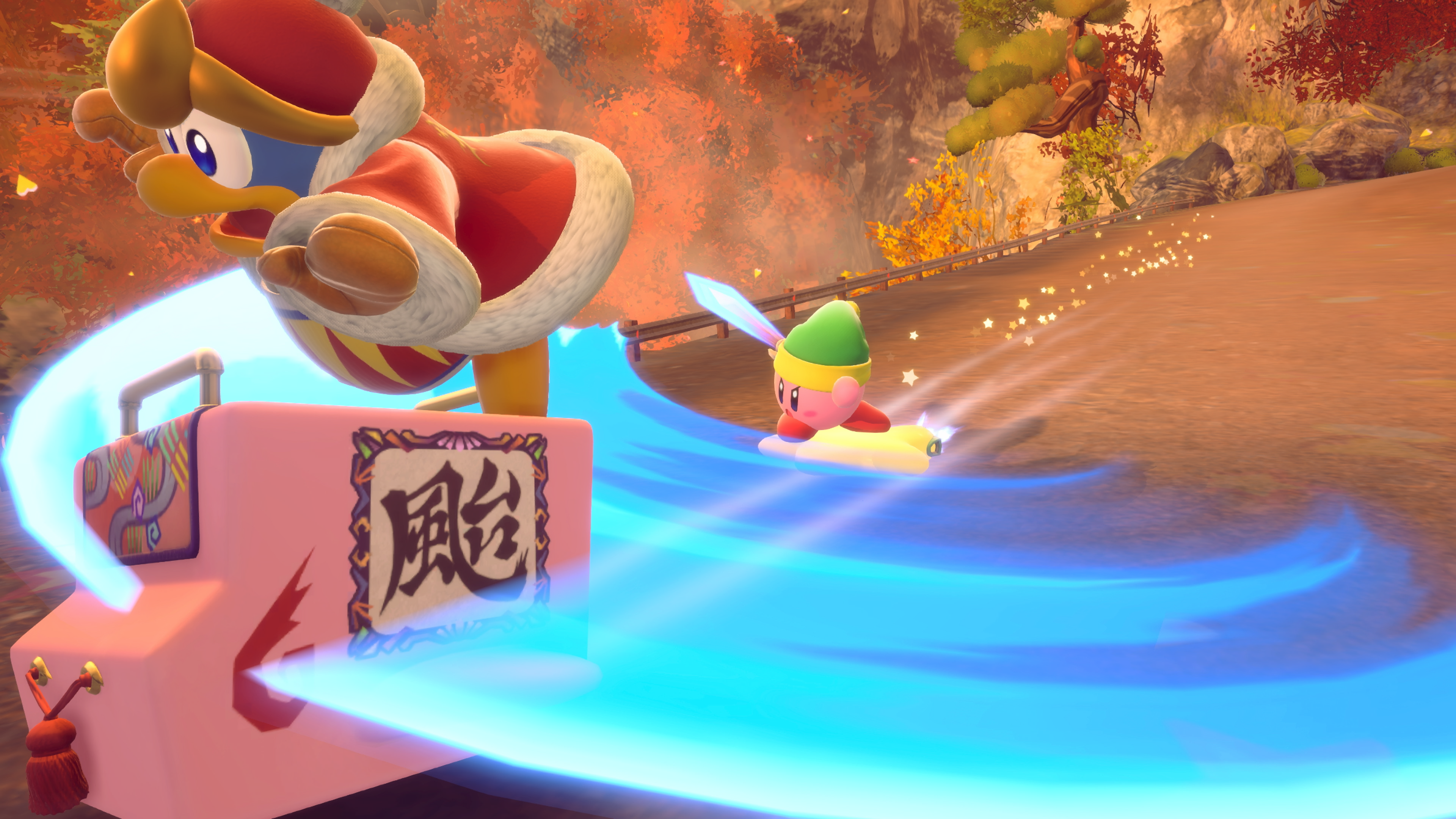 Re Dedede su un galleggiante rosa che soffia vento a Kirby, che cavalca una tavola da surf, con una spada. Lo sfondo è un paesaggio autunnale.