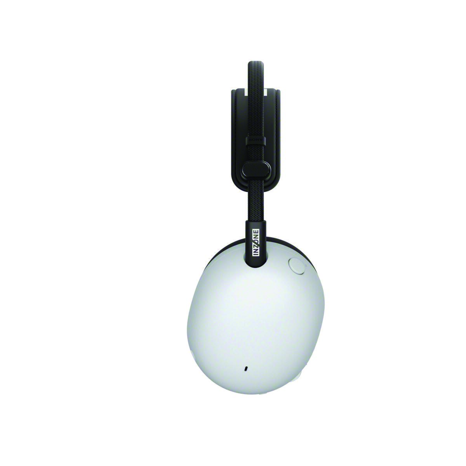 White and black INZONE headphones are hanging on a white background. The headphones have a round earcup and a black headband.