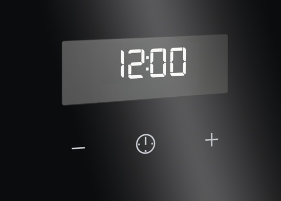 Czarny wyświetlacz urządzenia pokazuje 12:00. Poniżej wyświetlacza znajdują się symbole minus, zegar i plus.