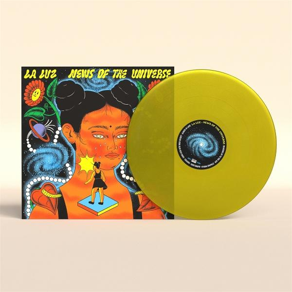 Albumcover mit Frauengesicht, gelbe Schallplatte. Text: 'LA LUZ NEWS OF THE UNIVERSE'.