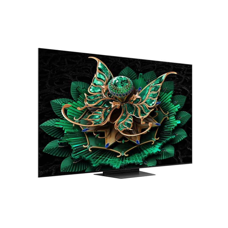 Bir TV ekranı, yeşil ve altın renkli bir çiçek deseni görüntüler. Ekran, dokulu siyah bir arka plan üzerinde, siyah bir stand üzerinde duruyor.
