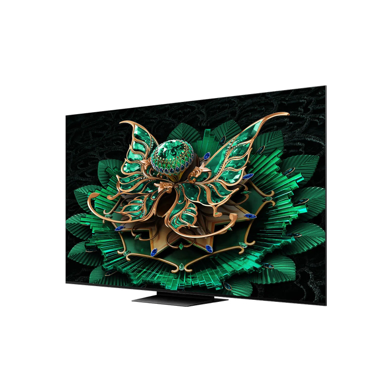Bir TV ekranı, siyah bir arka plan üzerinde kelebek benzeri bir yapıyla yeşil ve altın renkli bir çiçek tasarımının dekoratif bir görüntüsünü gösteriyor.