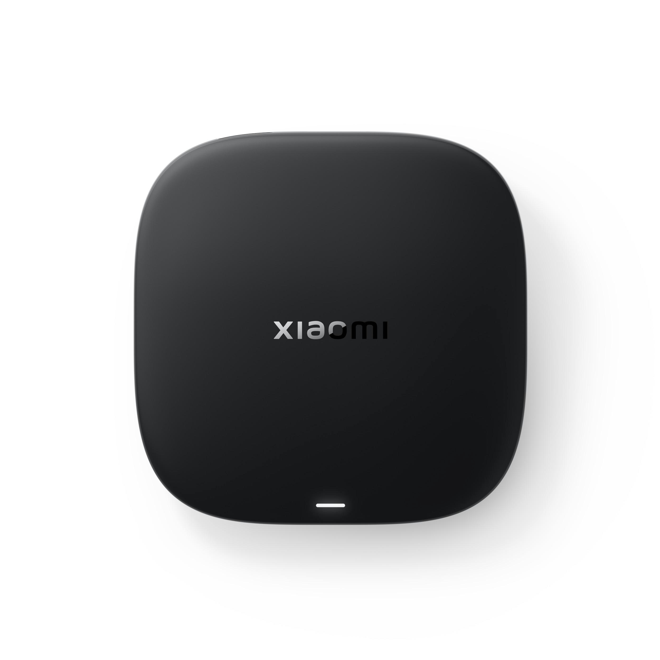 Ein schwarzes, abgerundetes quadratisches Gerät mit dem Wort 'xiaomi' und einem weißen Licht auf weißem Hintergrund.