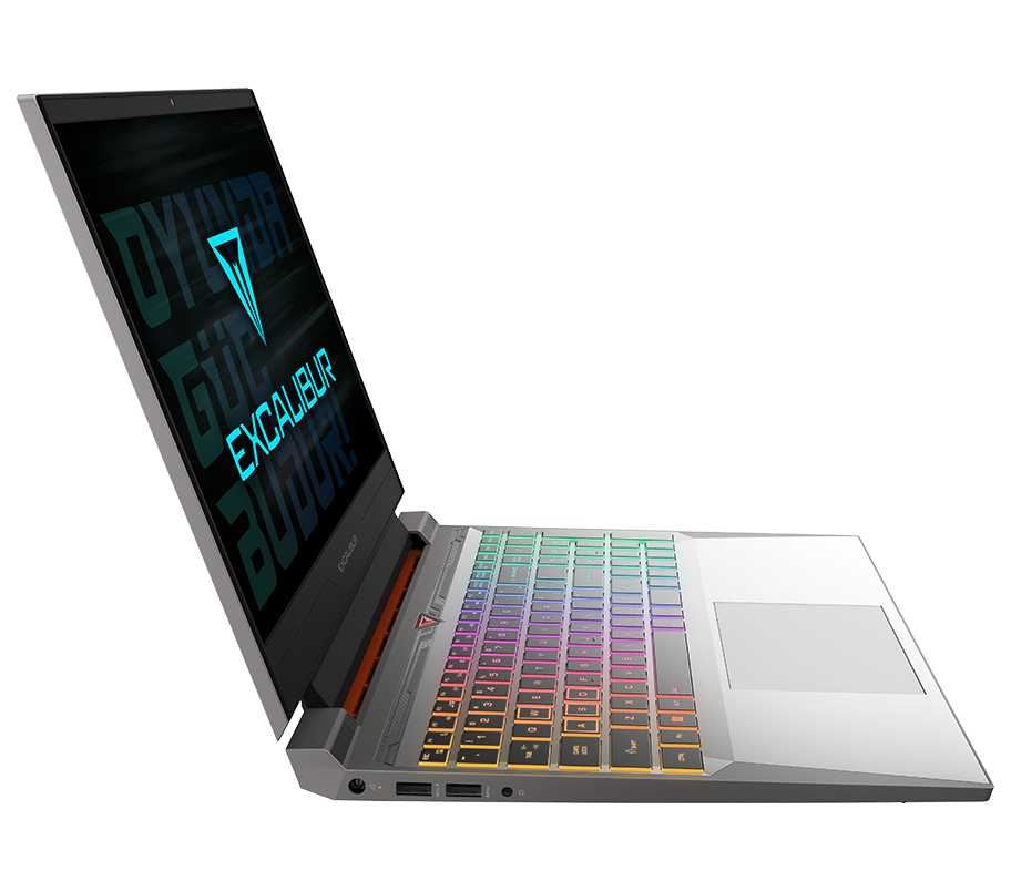 Açık bir oyun laptopu, renkli bir klavye ve metin içeren bir ekran gösteriyor. Arka planda yeşil bir blok ve beyaz çizgiler var.