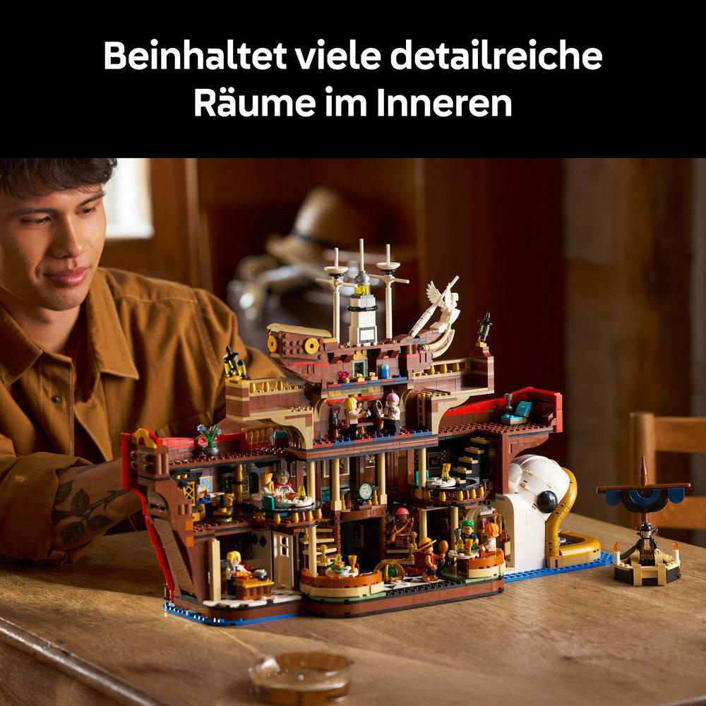 Ein Mann betrachtet ein detailliertes Lego-Schiffsmodell. Das Modell ist braun und hat mehrere Ebenen mit Miniaturfiguren.