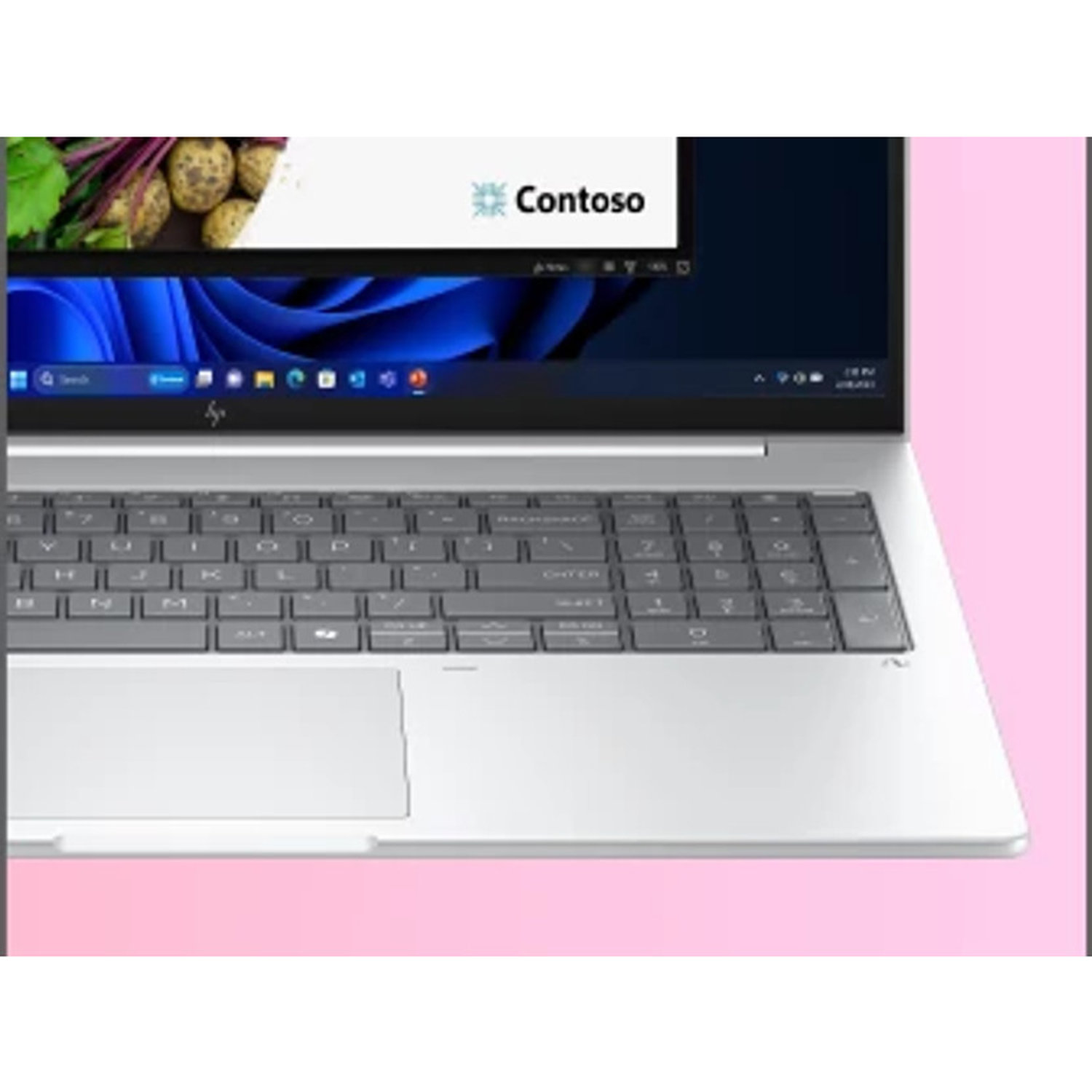 A laptop with a keyboard and touchpad, the screen showing a webpage, with a pink background. The brand is Contoso.