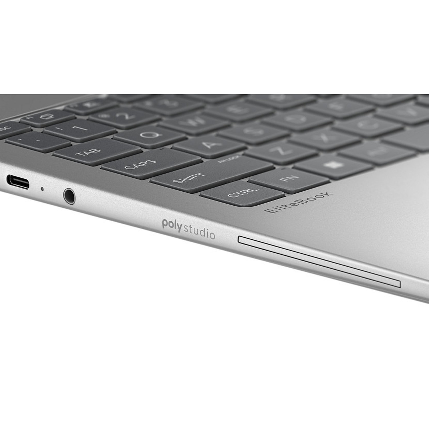 Close-up of a silver laptop keyboard. Keys are gray with white letters. The brand name 'poly studio' is visible on the laptop.