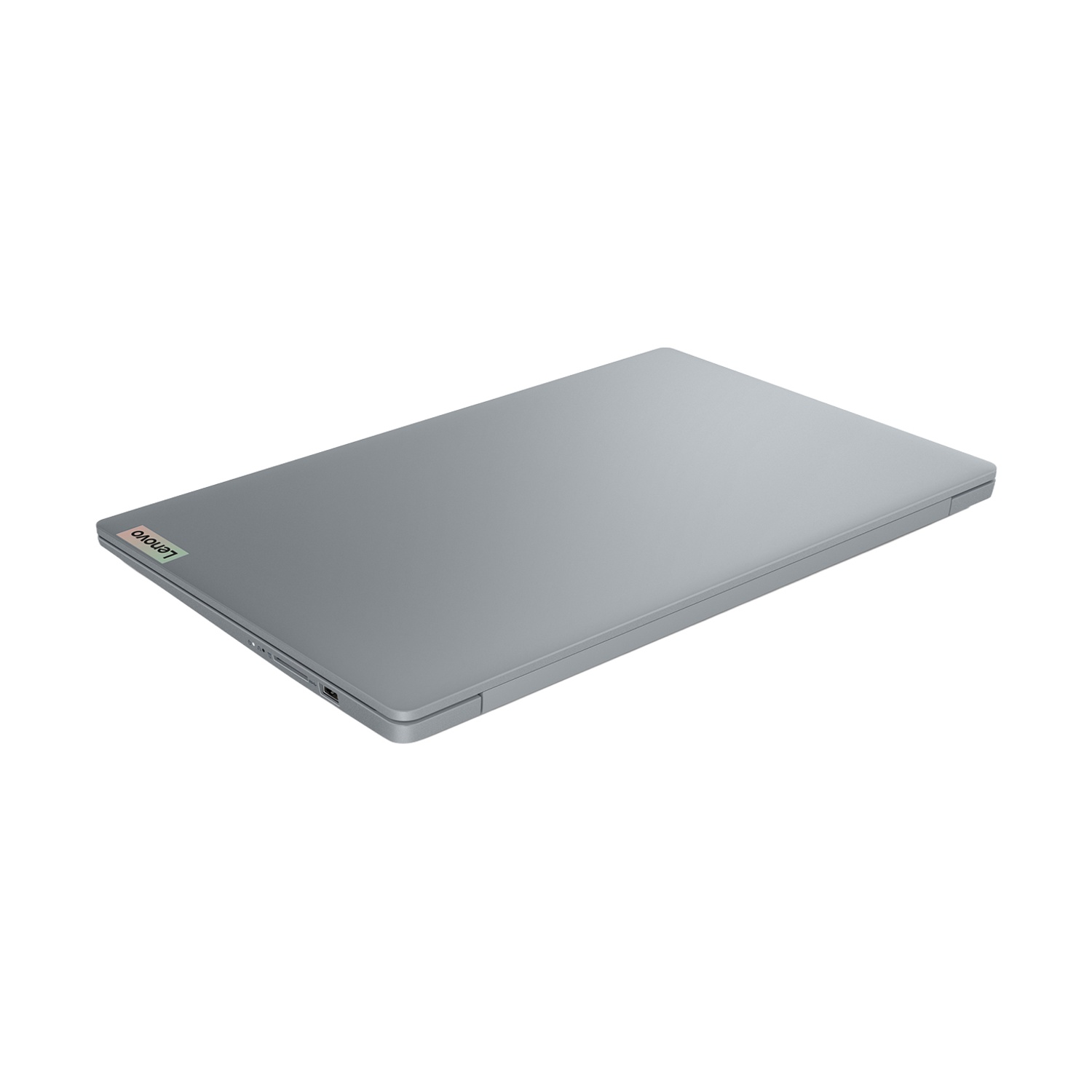 Un laptop Lenovo grigio chiuso su una superficie bianca. Il logo Lenovo è visibile nell'angolo in alto a sinistra.