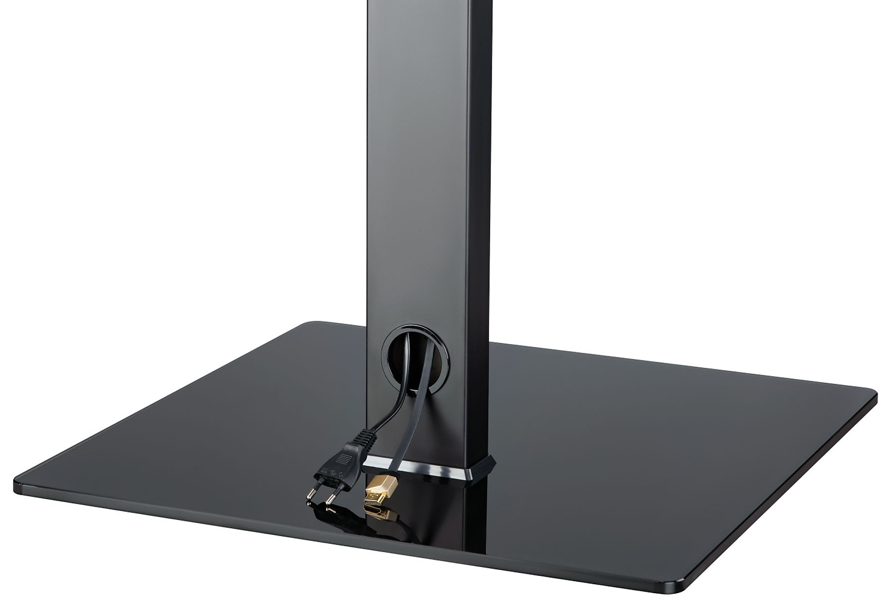 Czarny stojak pod telewizor z prostokątną podstawą i centralnym filarem. Widoczne kable i złącza.