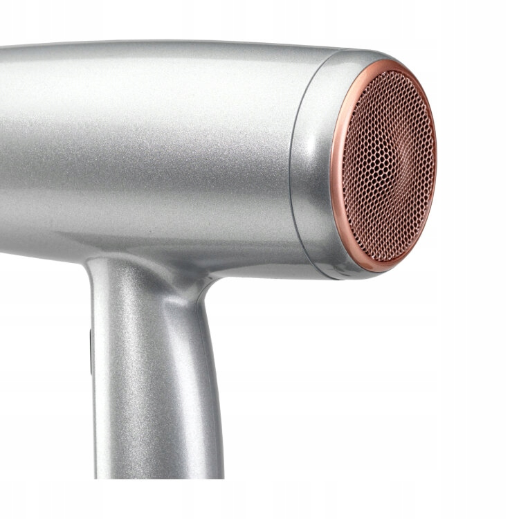 Srebrna suszarka do włosów z miedzianą dyszą z siatki. Uchwyt jest zakrzywiony. Tło jest jednolicie białe.