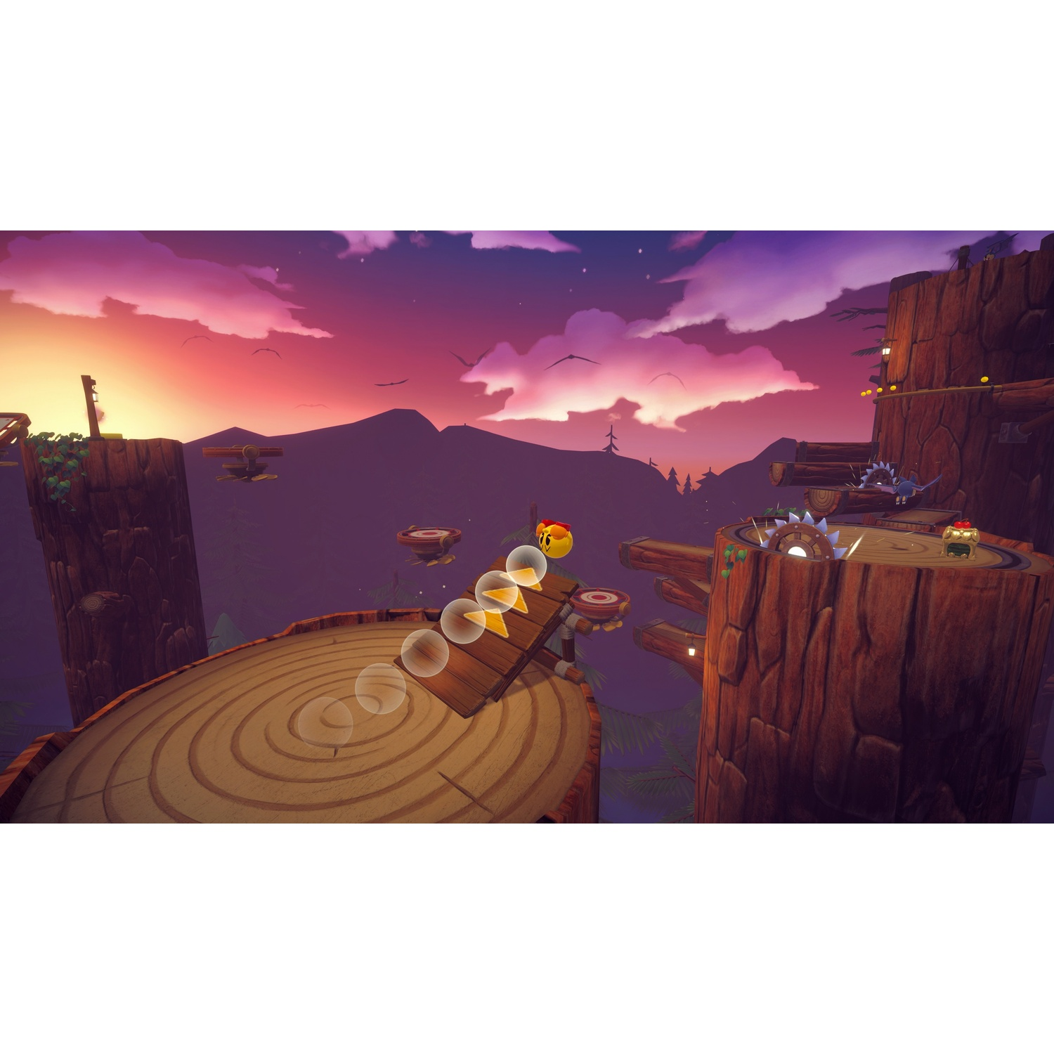 Una scena di gioco con un personaggio giallo che rotola su un sentiero di legno. Cielo viola con nuvole e montagne sullo sfondo. Piattaforme di legno.