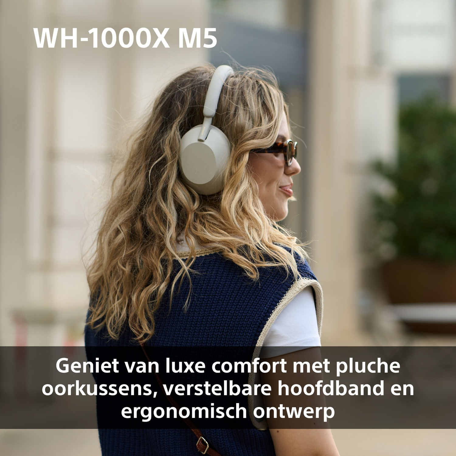 A woman with headphones smiles, wearing a dark blue sweater. Text overlay: WH-1000XM5. Comfortable design features are advertised.