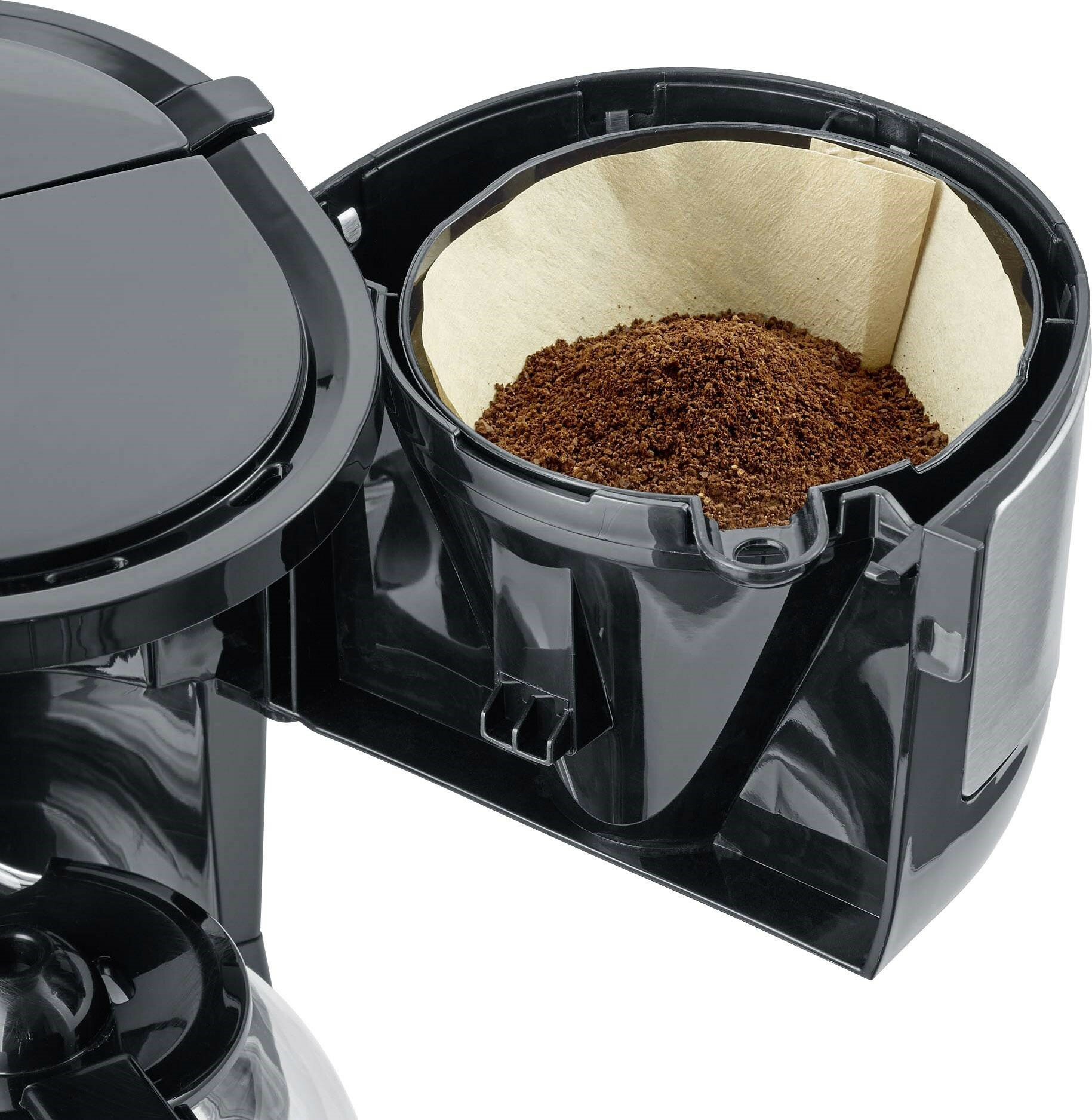 Czarny ekspres do kawy z filtrem zawierającym brązowe fusy. Widoczne są części pokrywy i karafki.