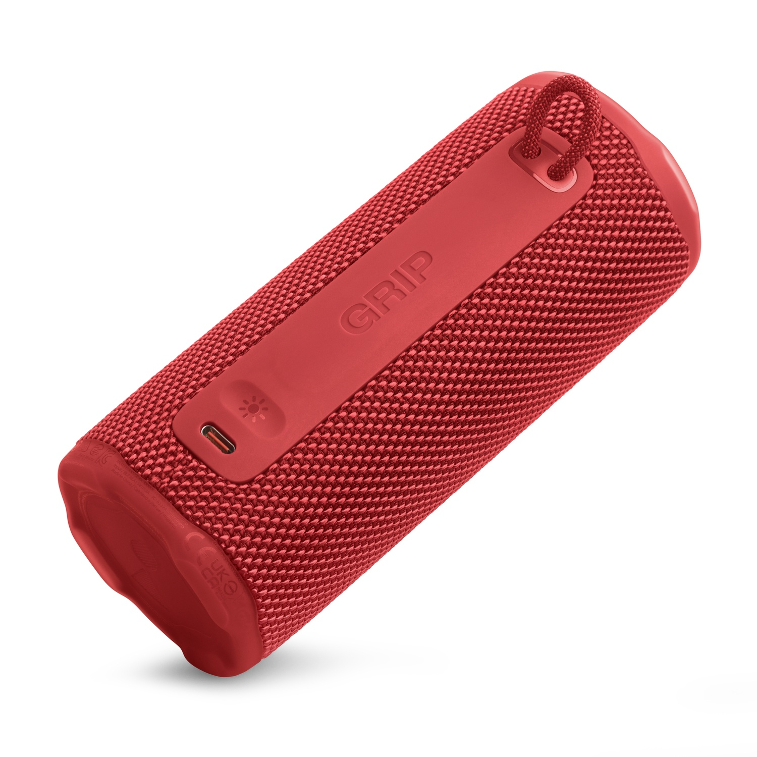 Un haut-parleur cylindrique rouge avec une texture en tissu. Il a une poignée, un port USB et le mot 'GRIP'.