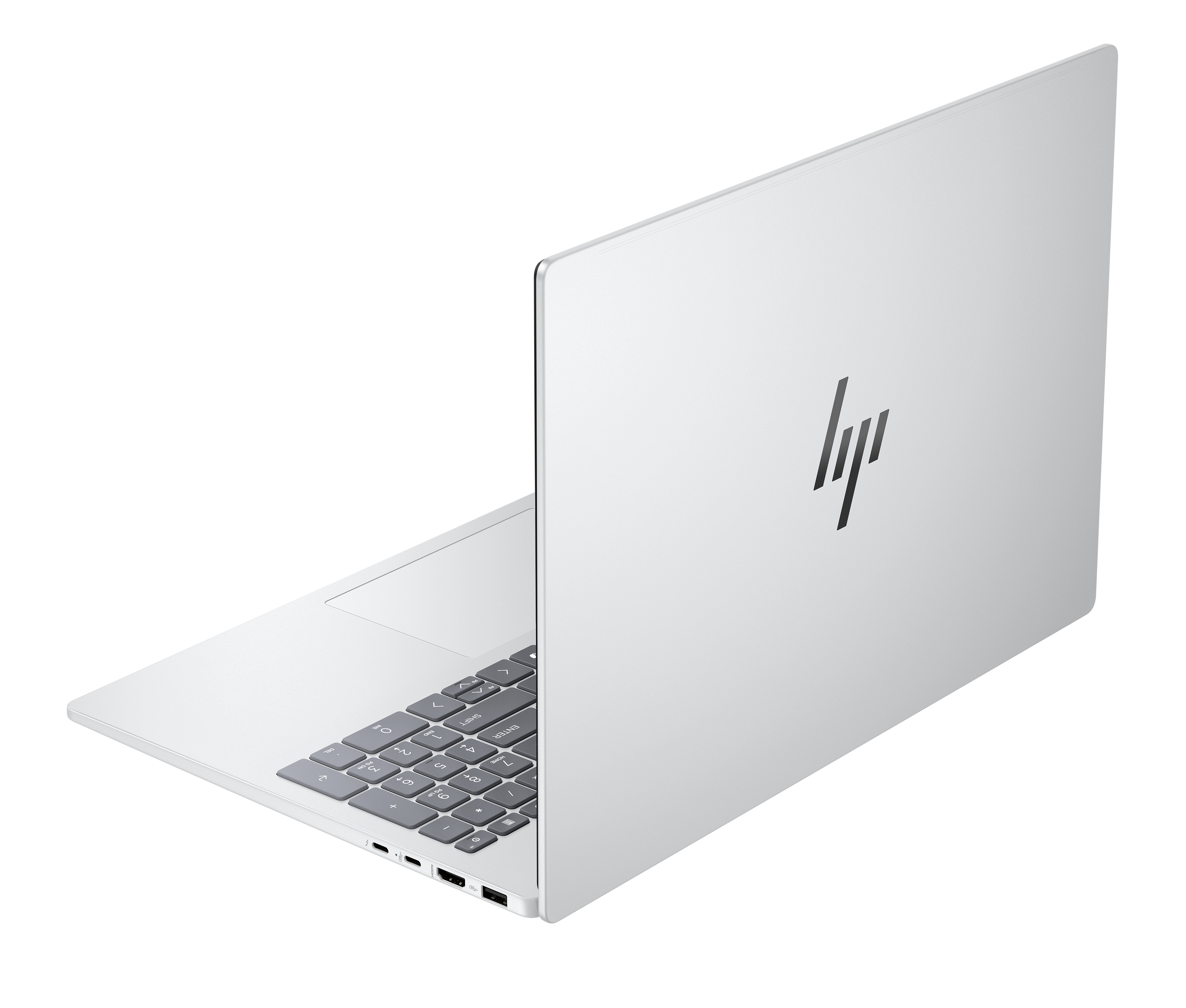 Un portátil HP plateado está abierto. El teclado es visible con teclas grises. El logotipo de HP está en la parte trasera.