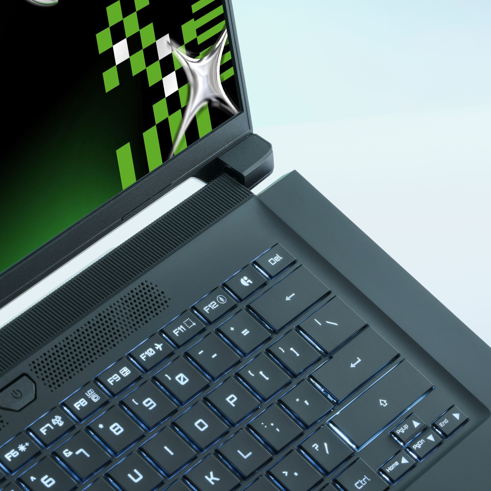 Laptop mit beleuchteter Tastatur, Bildschirm mit grünem und schwarzem Muster und silbernem sternförmigen Design.