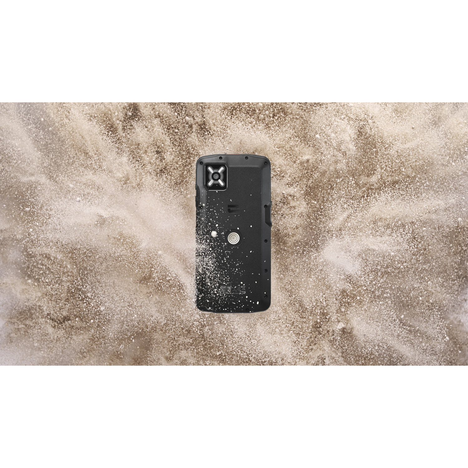 A black rugged smartphone lies on a sand-like background. The phone is centered, and the background has a powdery texture.