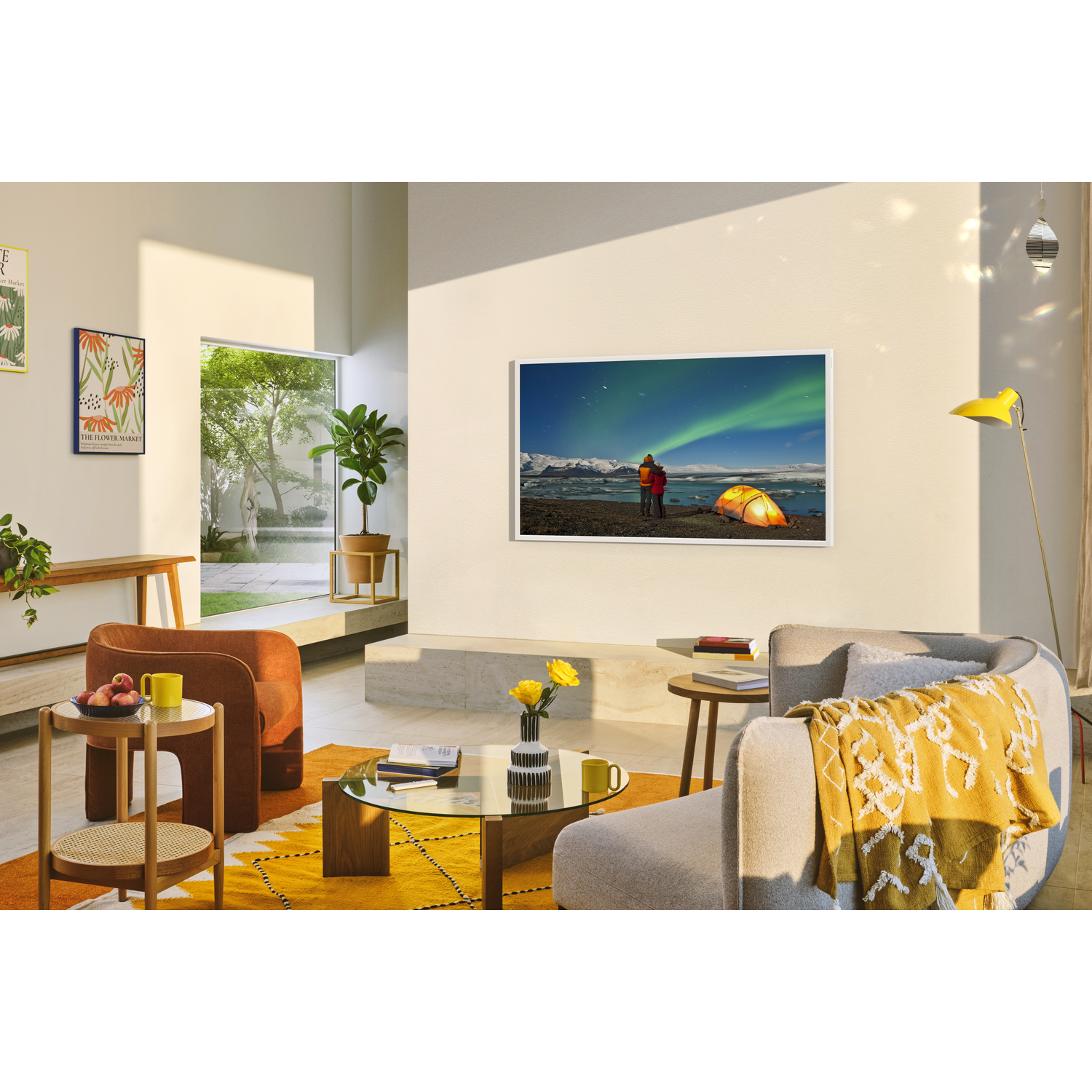 Living room with a TV showing aurora borealis, yellow blanket, orange chair, and yellow rug.