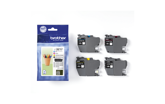 A Brother LC3217 ink cartridge pack and four individual cartridges are displayed on a white surface with a green backdrop.