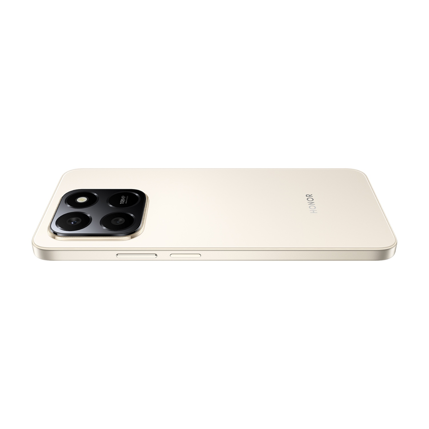 Uno smartphone Honor beige è in posizione orizzontale. Il modulo fotocamera con quattro lenti è in alto a sinistra. La scritta HONOR è visibile.