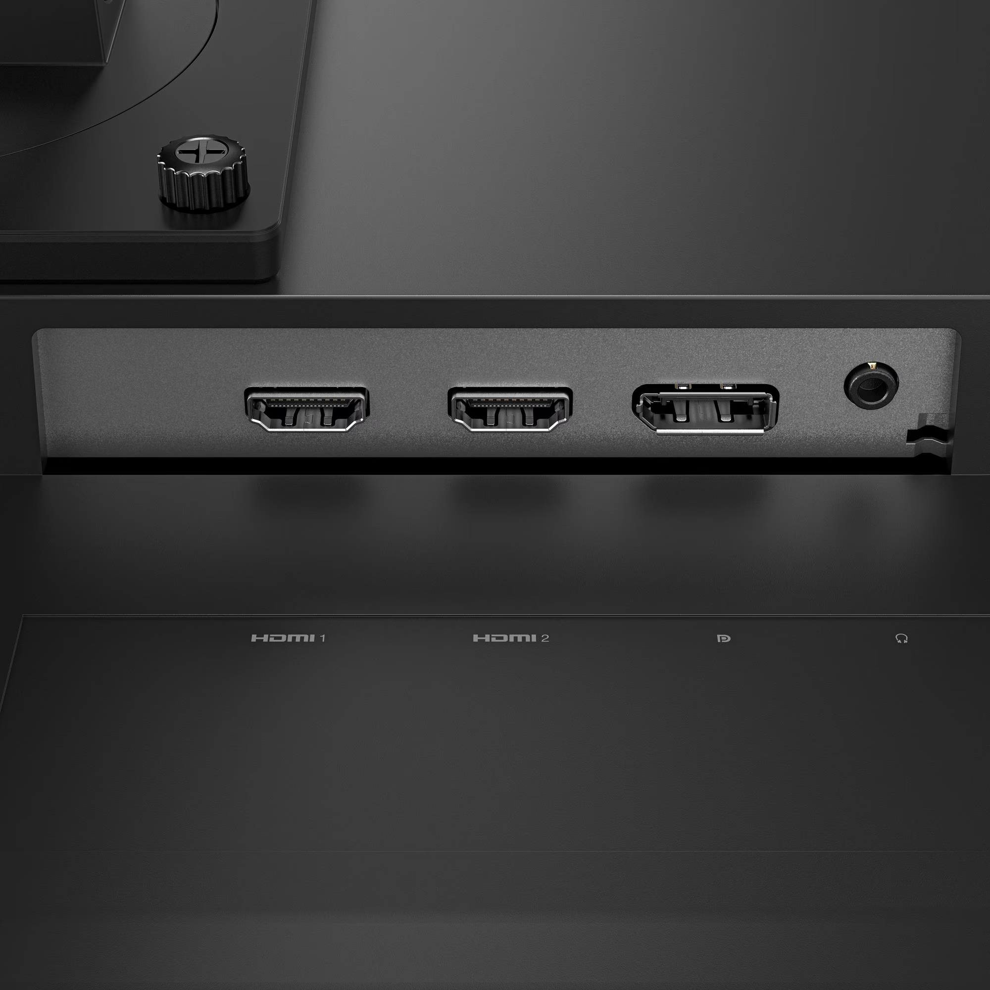 Zbliżenie na tył monitora z portami HDMI i gniazdem audio. Etykiety tekstowe HDMI 1, HDMI 2 oraz symbole zasilania i audio.