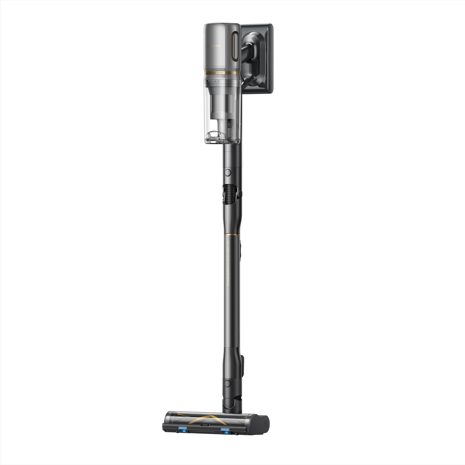 A cordless vacuum cleaner, predominantly gray and black, stands upright. It has a long handle, a dustbin, and a brush head.
