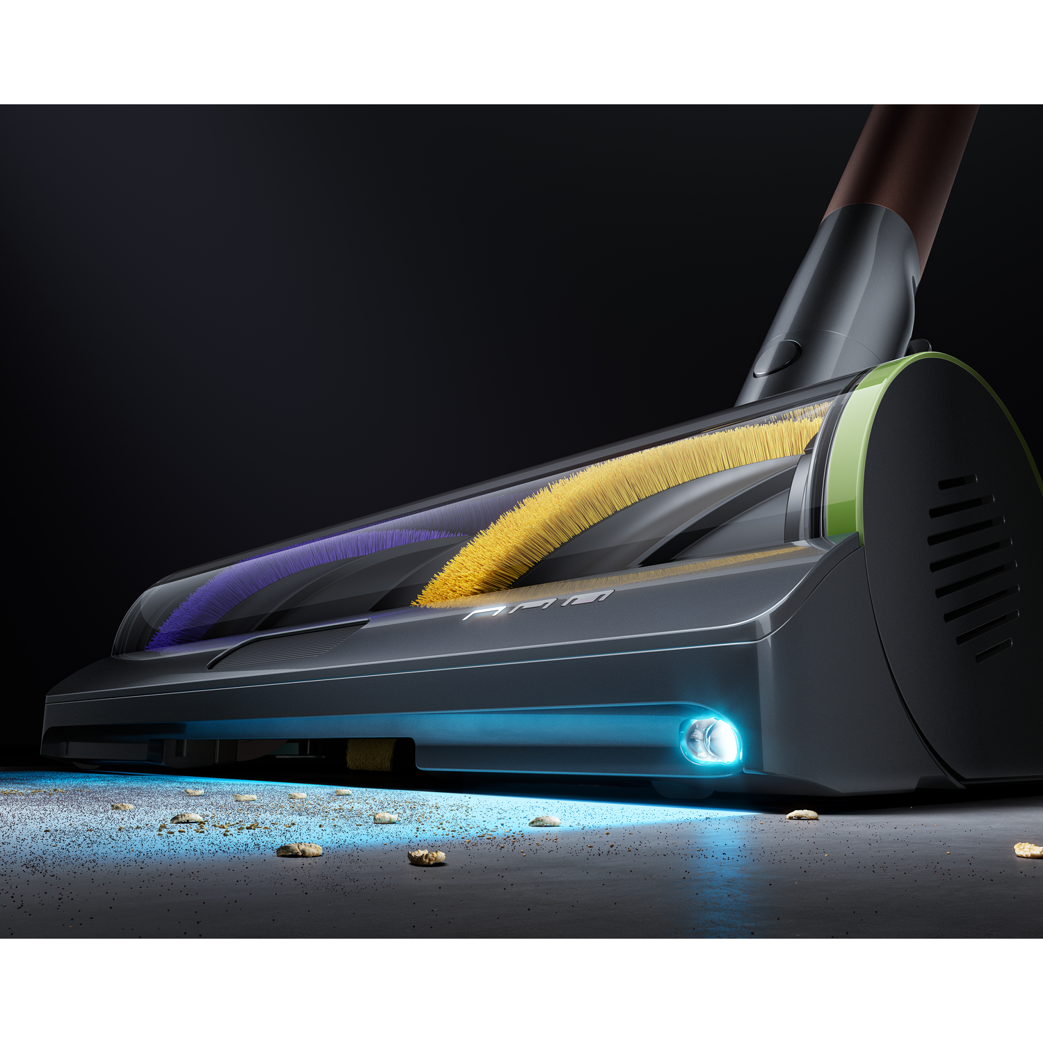 Close-up of a vacuum cleaner head with brush rollers. The floor has debris. Lighting highlights the cleaner's design and function.