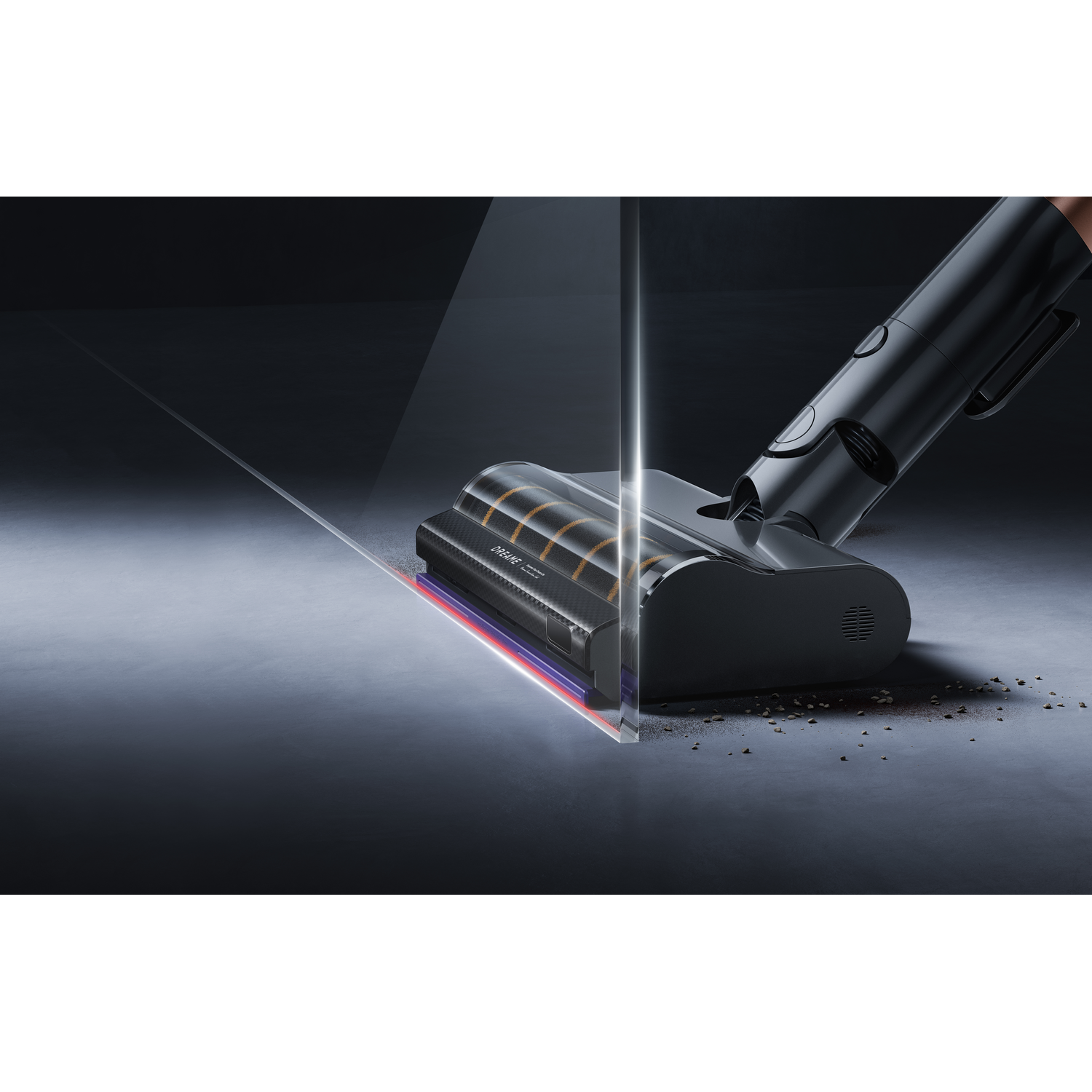 A black vacuum cleaner is shown on a dark surface. The vacuum head is highlighted with a transparent section, and dirt is visible.