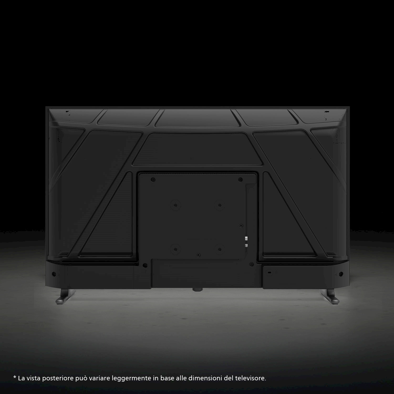 Vista posteriore di una TV nera con design geometrico su superficie grigia. Lo sfondo è nero.