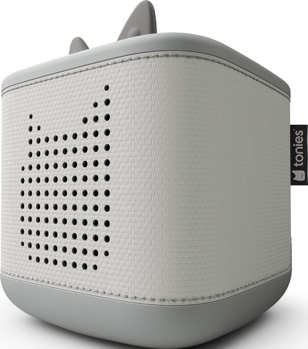 Un haut-parleur blanc et gris en forme de cube avec des découpes en forme de chat et des oreilles sur le dessus. Une étiquette 'tonies' est sur le côté.
