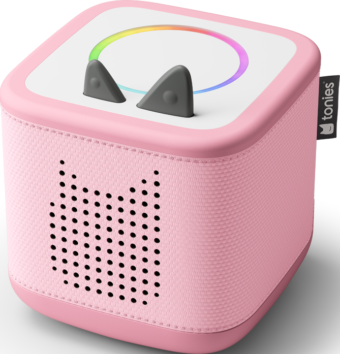 Eine rosafarbene, würfelförmige Toniebox mit grauen Katzenohren und einem Regenbogenlicht. Sie hat einen Lautsprecher mit Katzengesicht und ein 'tonies'-Etikett.
