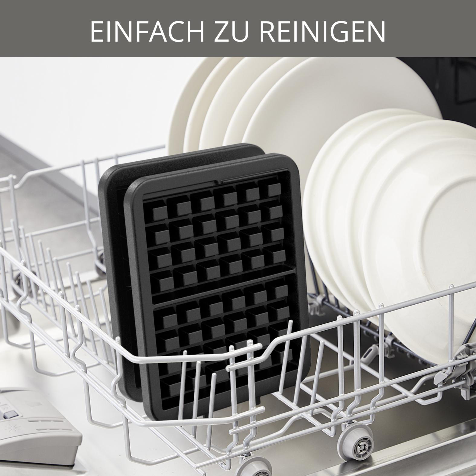 Schwarzes Waffeleisen in einer Spülmaschine. Weiße Teller sind im Hintergrund. Oben steht 'Einfach zu Reinigen'.