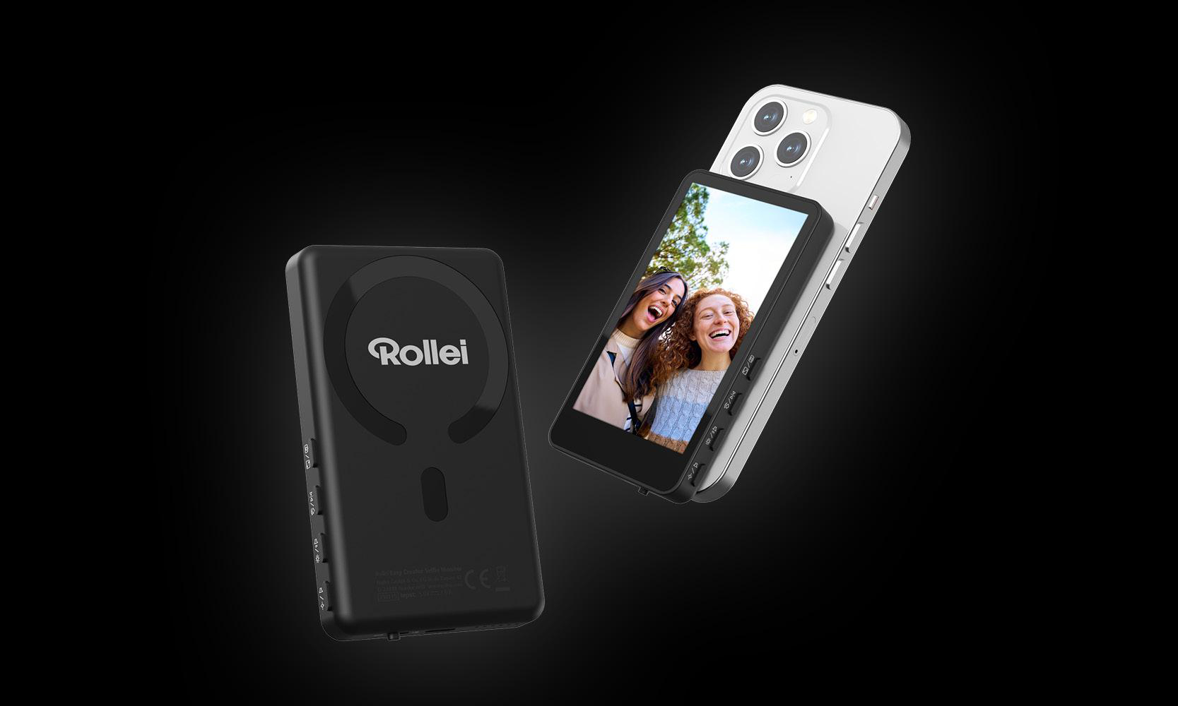 Ein schwarzes Rollei-Gerät und ein silbernes Smartphone mit einem Bildschirm, der zwei lächelnde Frauen zeigt. Der Hintergrund ist schwarz.