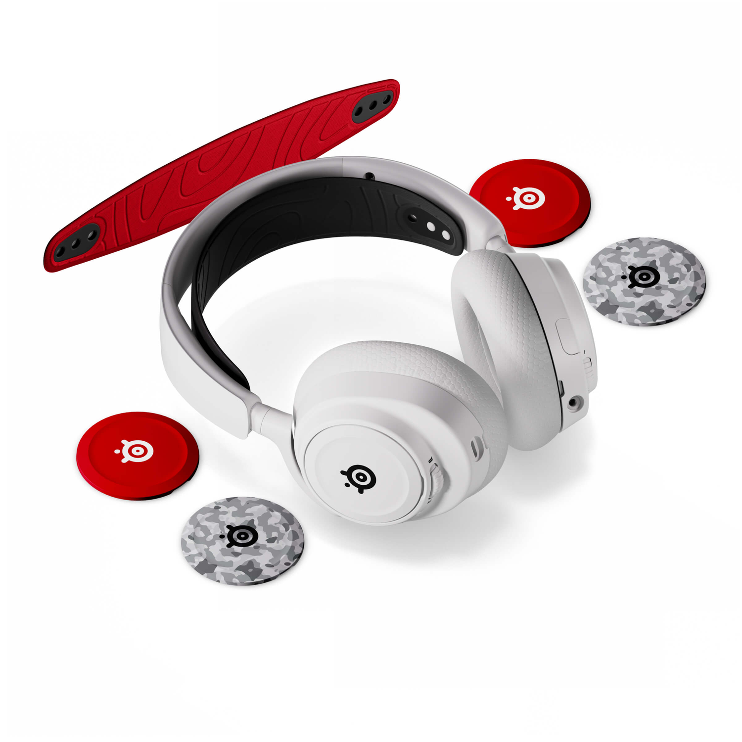 White headphones with red and camouflage ear covers. A red headband is on top. All on a white background.
