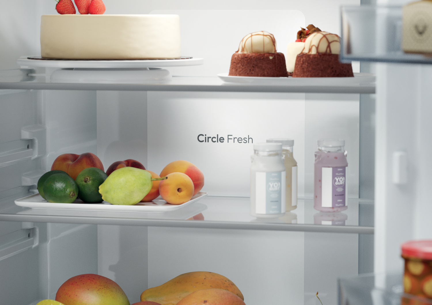 Dentro de un refrigerador, un pastel con fresas, pasteles pequeños, frutas como mangos, melocotones y botellas de yogur son visibles.