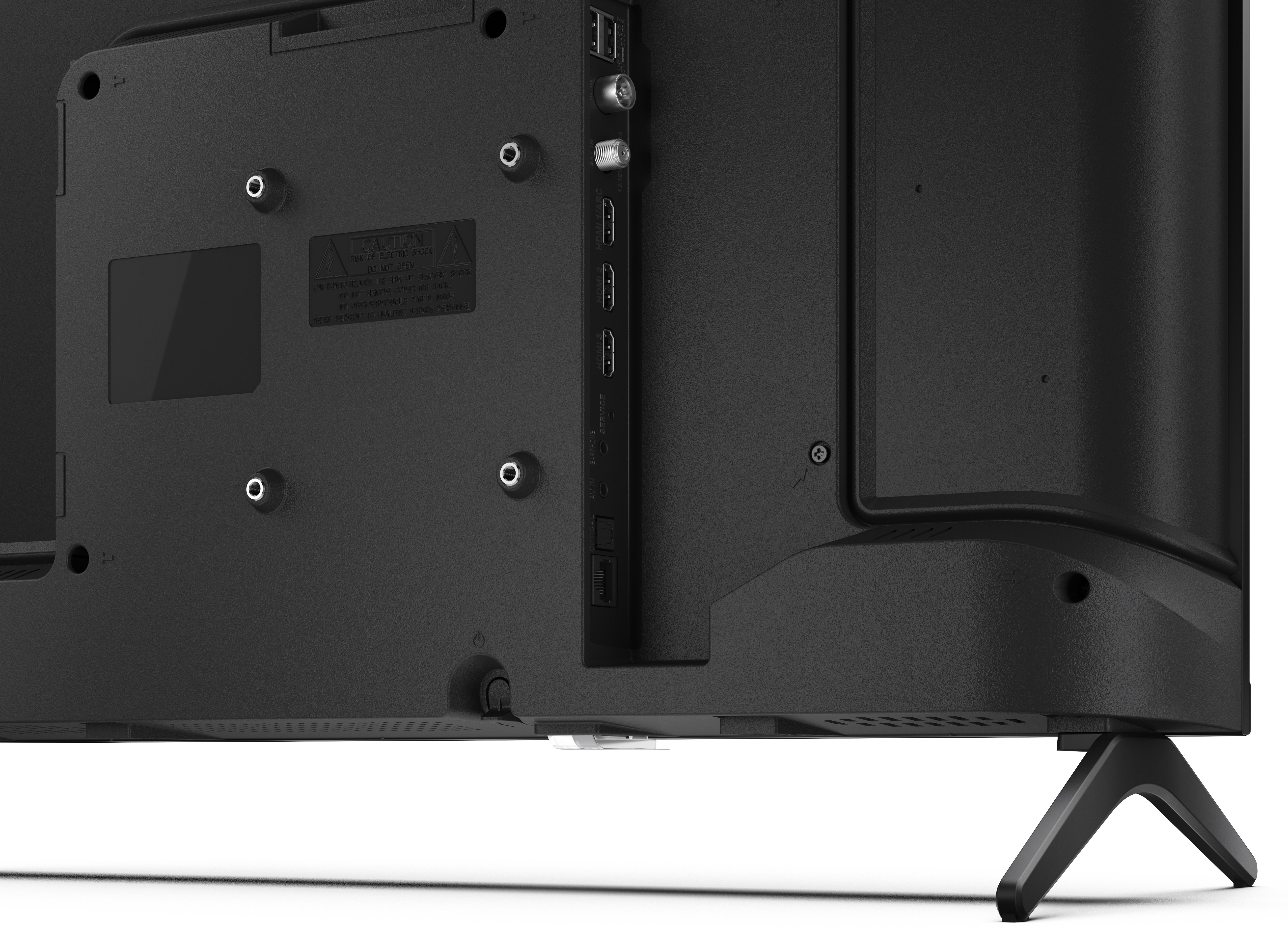Zbliżenie tyłu czarnego telewizora z portami i etykietą ostrzegawczą. Telewizor stoi na białej powierzchni.